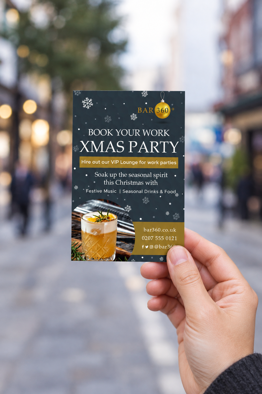 A6-sized Christmas-party flyer held in a hand